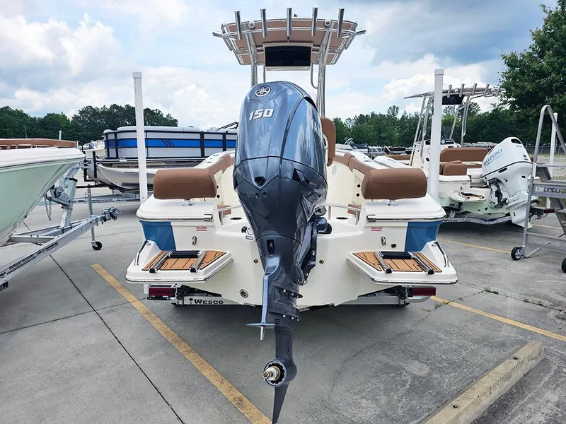 Slide: The Image of 2025 Pioneer 202 Sportfish boat with Yamaha 150 engine, parked in a marina. - 6