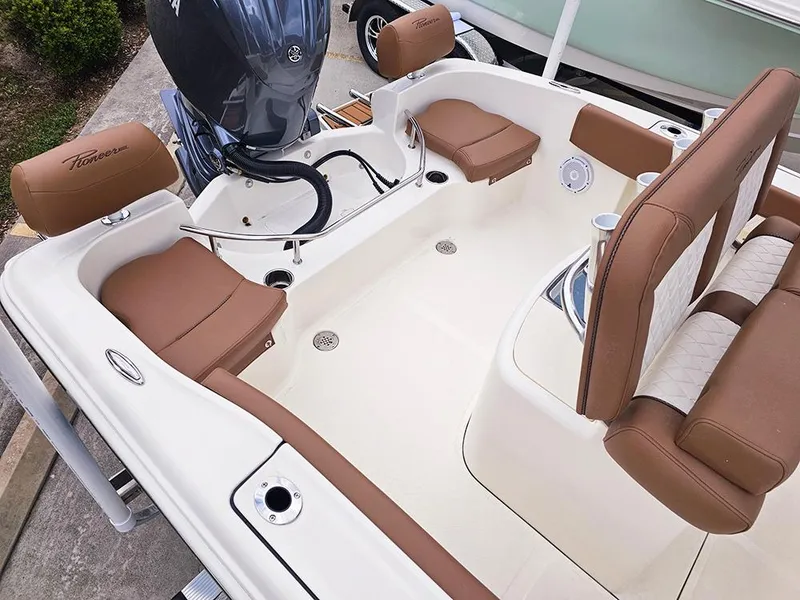 Slide: The Image of 2025 Pioneer 202 Sportfish boat interior with brown seating and modern design. - 8