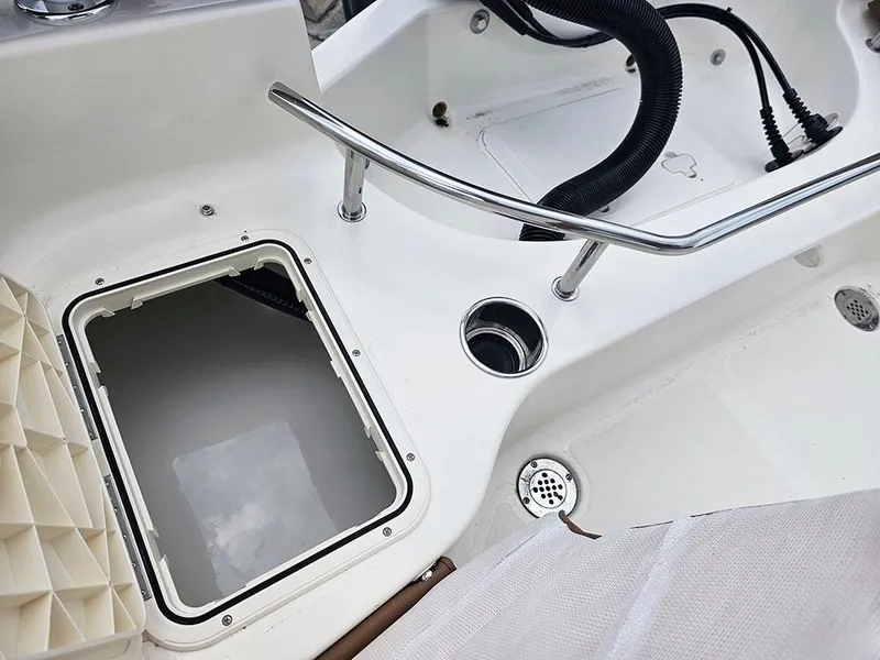 Slide: The Image of 2025 Pioneer 202 Sportfish boat deck with open hatch and stainless steel railing. - 9