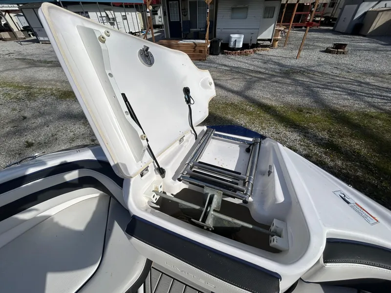 Slide: The Image of 2020 Yamaha Boats 242 Limited S with open storage compartment and ladder on deck. - 15