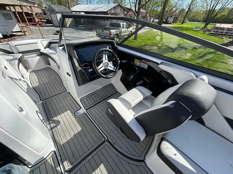 Slide: The Image of 2020 Yamaha Boats 242 Limited S interior with sleek design and modern steering console. - 21