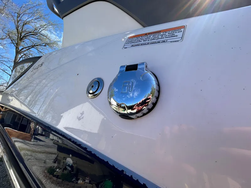 Slide: The Image of 2020 Yamaha Boats 242 Limited S, close-up of chrome fuel cap on white exterior. - 28