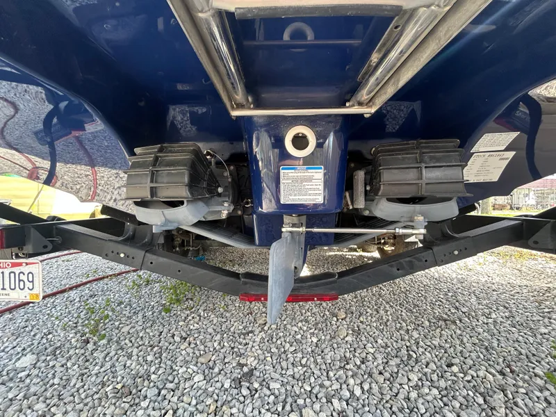 Slide: The Image of 2020 Yamaha Boats 242 Limited S underside view on gravel surface. - 3