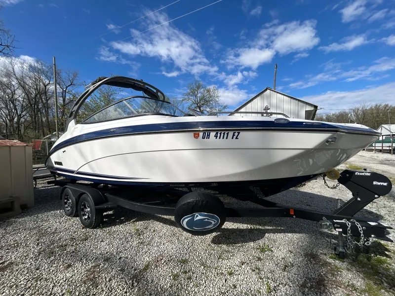 Slide: The Image of 2020 Yamaha Boats 242 Limited S on trailer, parked outdoors under blue sky. - 6