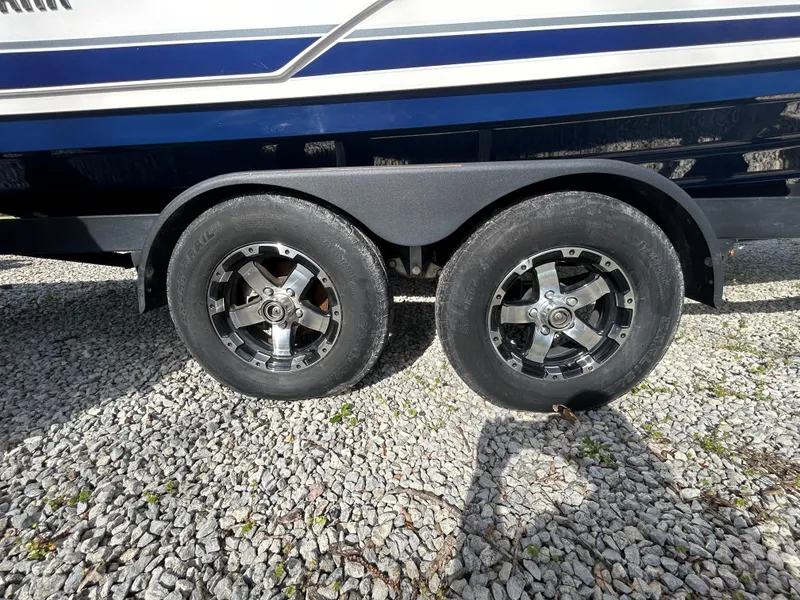 Slide: The Image of Trailer wheels of a 2020 Yamaha Boats 242 Limited S on gravel. - 7