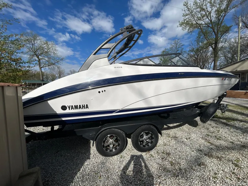 Slide: The Image of 2020 Yamaha Boats 242 Limited S on trailer, parked outdoors under blue sky. - 8