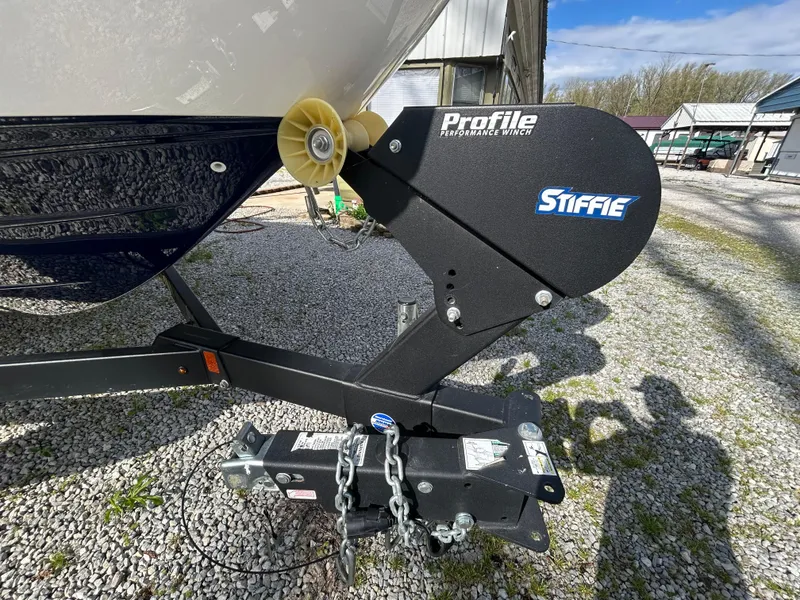 Slide: The Image of 2020 Yamaha Boats 242 Limited S trailer with Profile winch on gravel surface. - 9