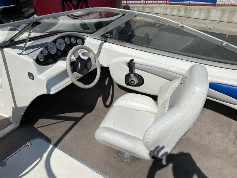 Slide: The Image of 2007 Stingray 195LR boat interior with white seating and dashboard controls. - 4