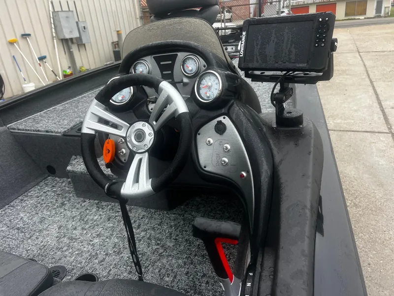 Slide: The Image of 2021 Bass Tracker 195 TX boat dashboard with steering wheel and electronic display. - 10