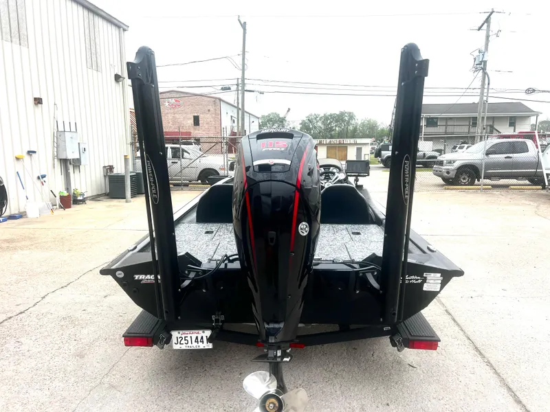 Slide: The Image of Bass Tracker 195 TX 2021 boat with motor, parked outdoors, rear view. - 3