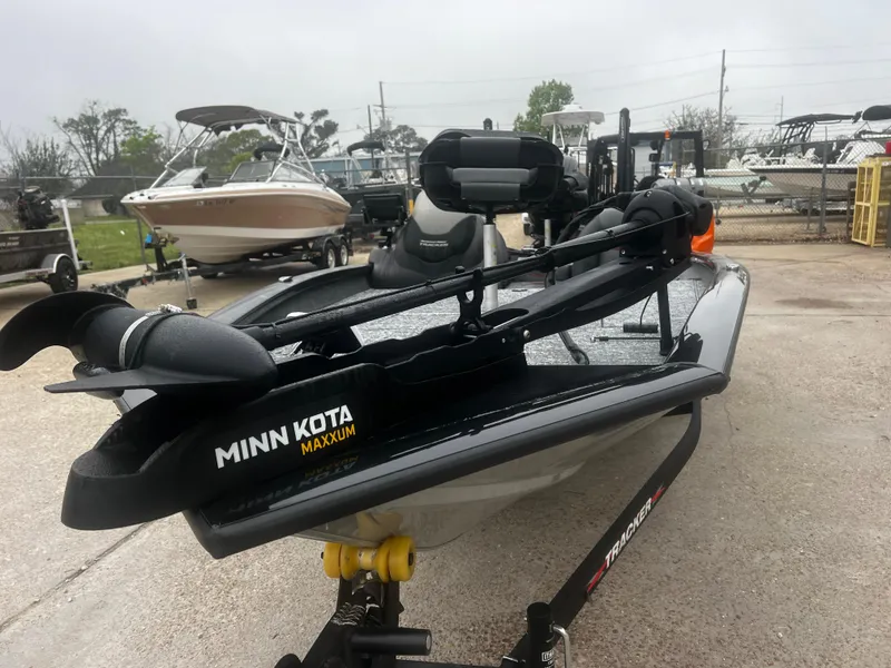 Slide: The Image of 2021 Bass Tracker 195 TX boat with Minn Kota Maxxum trolling motor in a marina. - 5