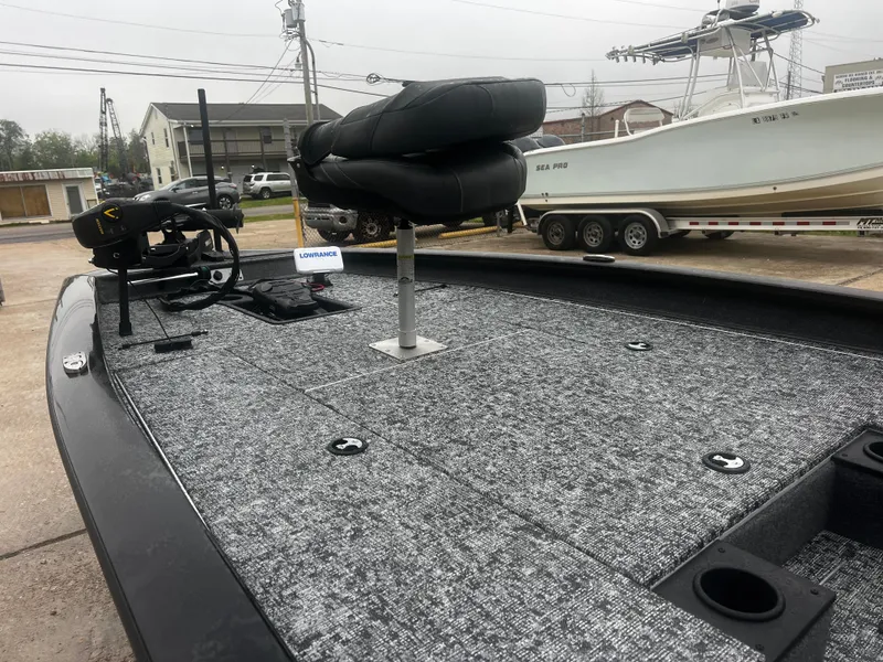 Slide: The Image of 2021 Bass Tracker 195 TX fishing boat with carpeted deck and seating. - 7