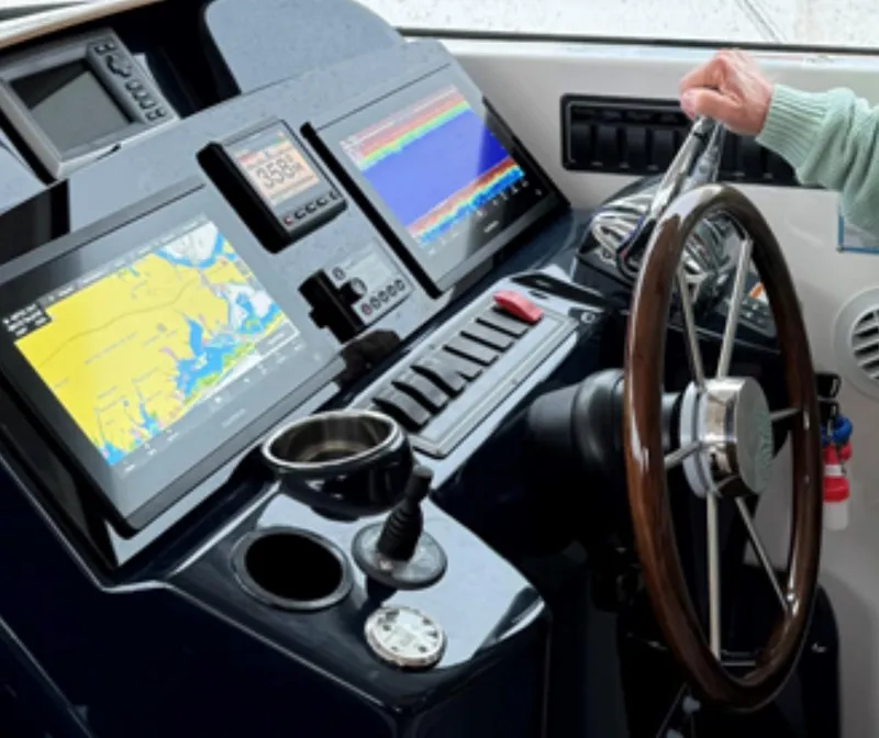 Slide: The Image of Helm of 2013 Tiara Yachts 3600 Coronet with navigation screens and steering wheel. - 16