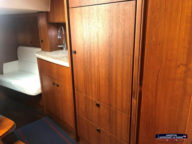 Slide: The Image of 2013 Tiara Yachts 3600 Coronet interior with wood cabinetry and white seating. - 19