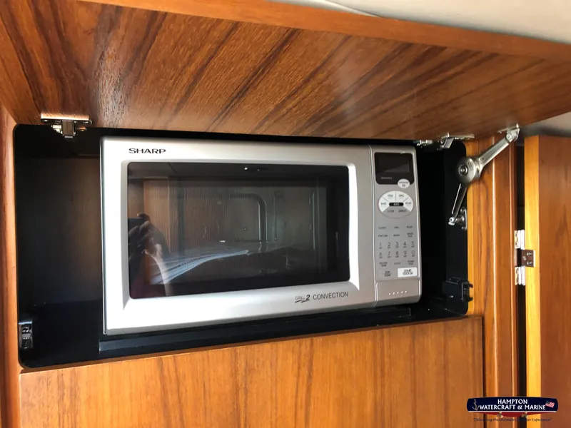 Slide: The Image of Microwave in 2013 Tiara Yachts 3600 Coronet, wooden cabinet interior. - 20