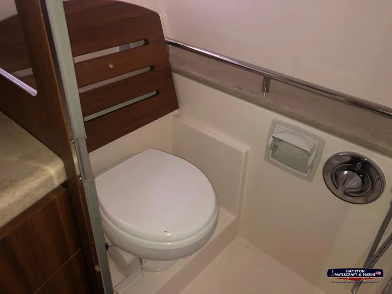 Slide: The Image of 2013 Tiara Yachts 3600 Coronet bathroom with toilet and wooden accents. - 26