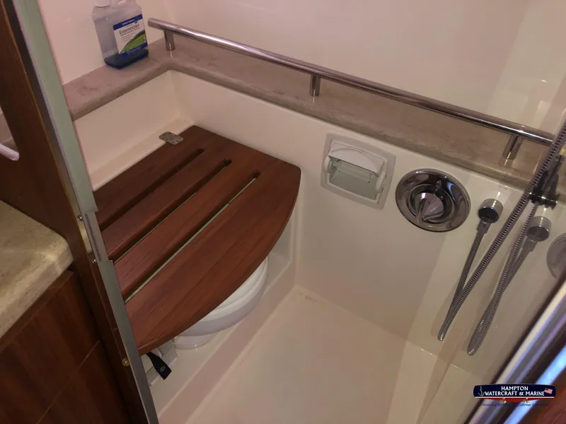 Slide: The Image of 2013 Tiara Yachts 3600 Coronet bathroom with wooden seat and shower fixtures. - 27