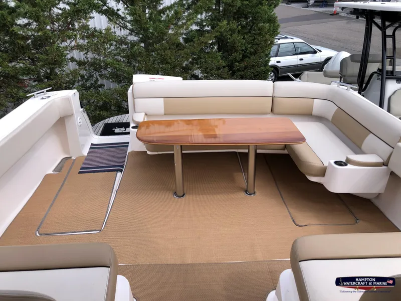 Slide: The Image of 2013 Tiara Yachts 3600 Coronet interior with beige seating and wooden table. - 5