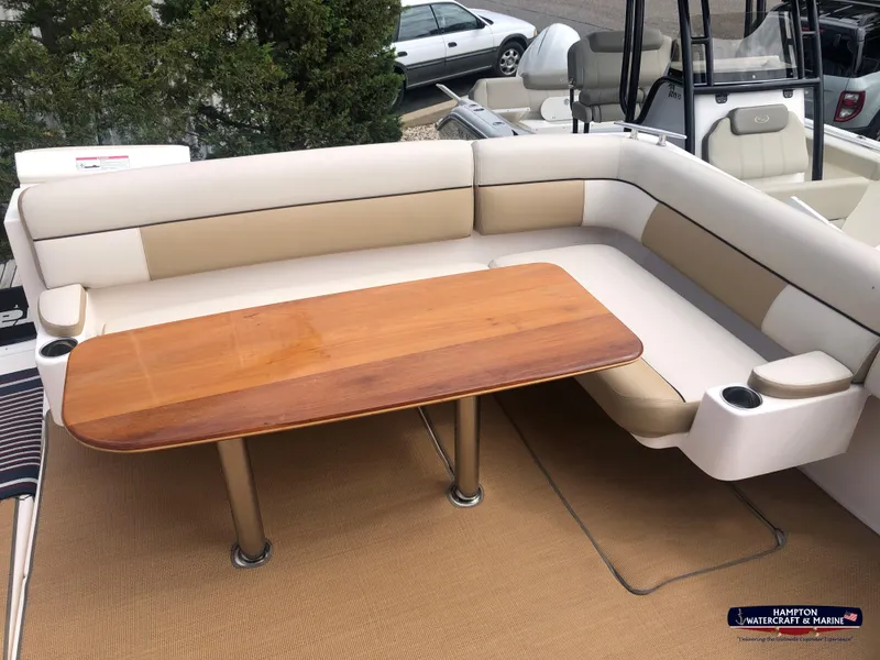 Slide: The Image of 2013 Tiara Yachts 3600 Coronet with beige seating and wooden table on deck. - 6