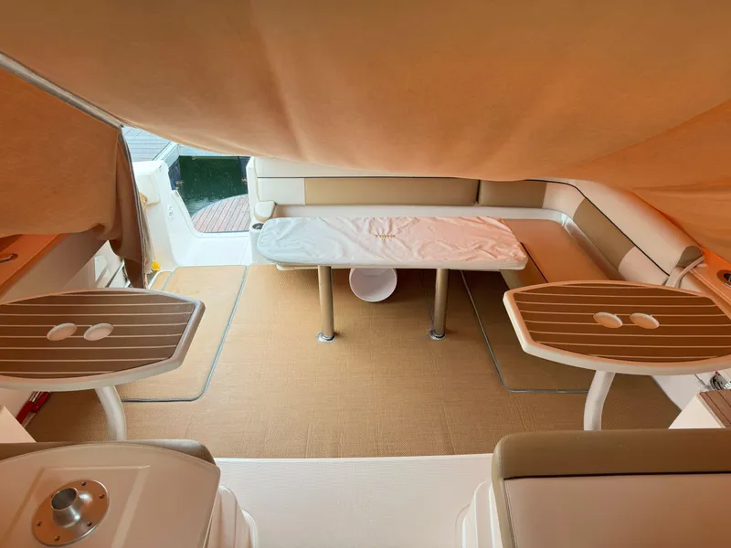 Slide: The Image of 2013 Tiara Yachts 3600 Coronet interior with seating and tables under a canopy. - 7