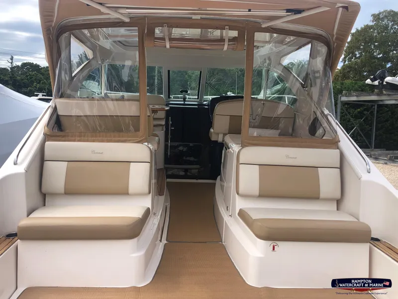 Slide: The Image of 2013 Tiara Yachts 3600 Coronet interior with beige seating and clear enclosures. - 8