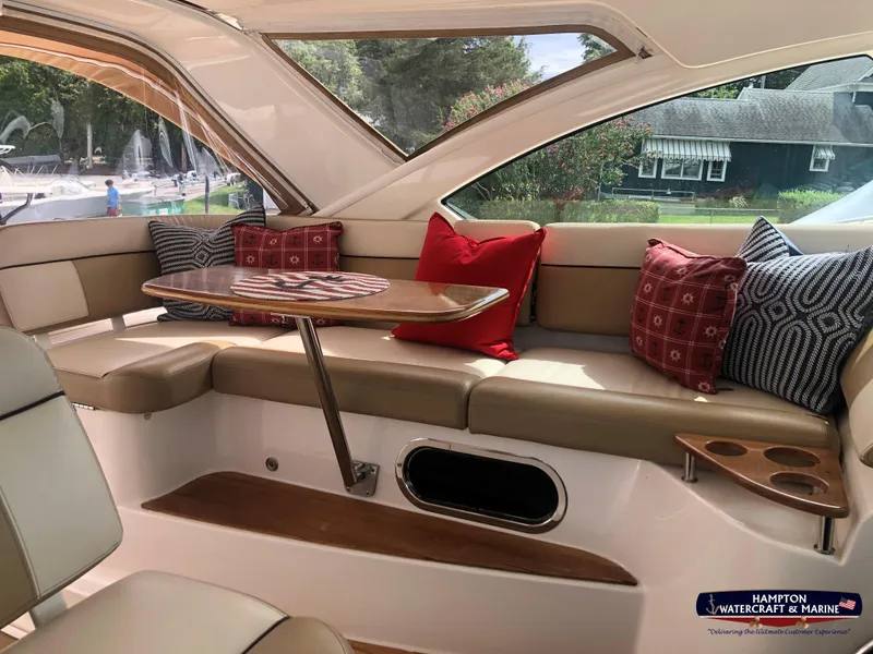 Slide: The Image of 2013 Tiara Yachts 3600 Coronet interior with cushioned seating and decorative pillows. - 9