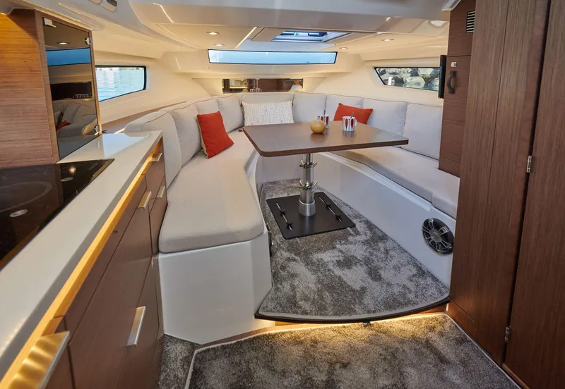 Slide: The Image of Interior of 2025 Jeanneau Leader 10.5 WA Series 2, featuring modern seating and dining area. - 10