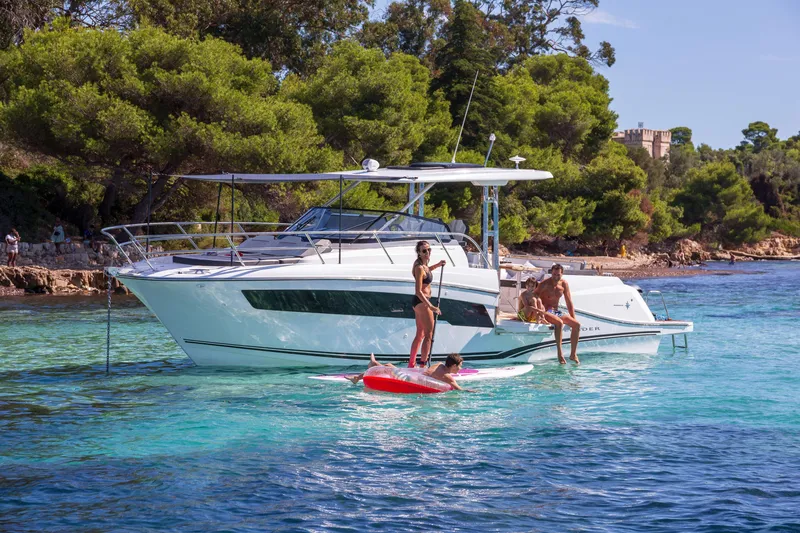 Slide: The Image of 2025 Jeanneau Leader 10.5 WA Series 2 yacht in clear blue water, people enjoying leisure activities. - 15