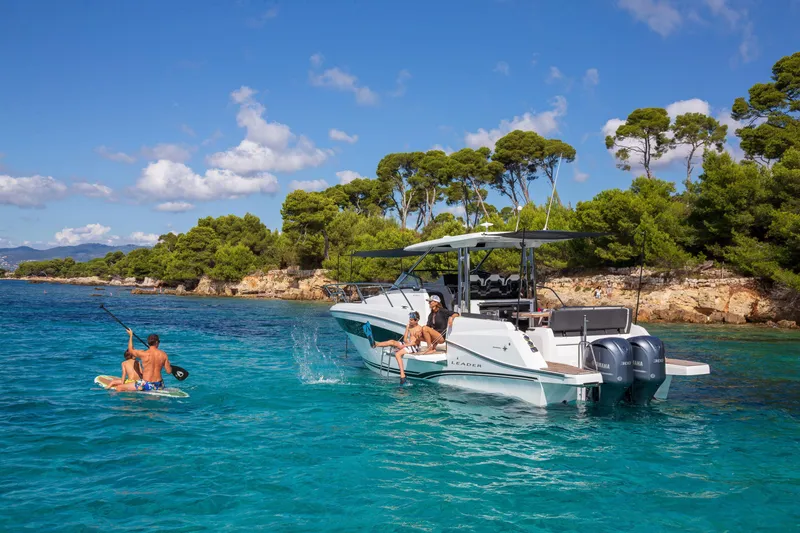 Slide: The Image of 2025 Jeanneau Leader 10.5 WA Series 2 boat in clear blue water, people enjoying water activities. - 18
