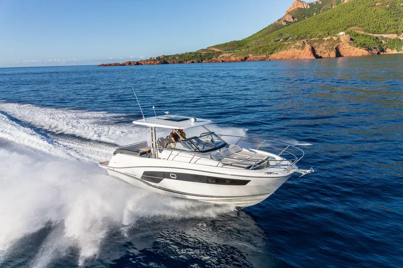 Slide: The Image of 2025 Jeanneau Leader 10.5 WA Series 2 cruising on open water, scenic coastal backdrop. - 4