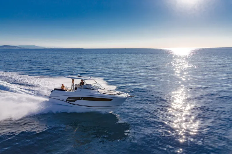 Slide: The Image of 2025 Jeanneau Leader 10.5 WA Series 2 cruising on open sea under clear blue sky. - 14