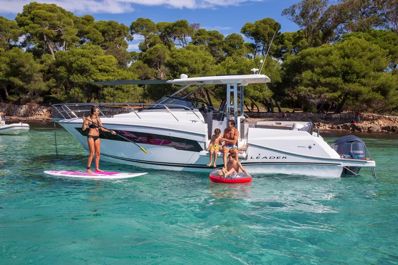 Slide: The Image of 2025 Jeanneau Leader 10.5 WA Series 2 yacht with people enjoying water activities nearby. - 7