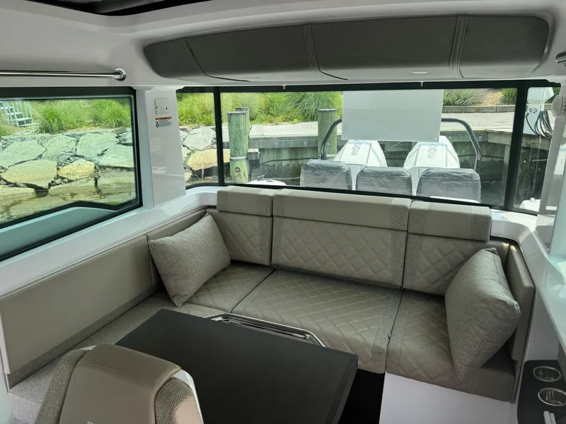 Slide: The Image of 2024 Axopar 37 Cross Cabin XC interior cabin with skylights and modern bedding. - 18