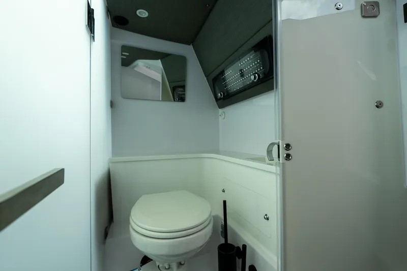 Slide: The Image of 2024 Axopar 37 Cross Cabin XC interior storage cabinets with open doors. - 21