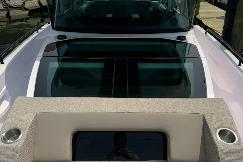 Slide: The Image of 2024 Axopar 37 Cross Cabin XC docked near a waterfront building. - 3