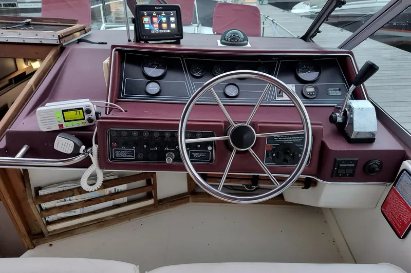Slide: The Image of 1989 Sea Ray 268 Sun Dancer dashboard with steering wheel and navigation instruments. - 17