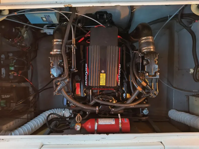 Slide: The Image of Engine compartment of a 1989 Sea Ray 268 Sun Dancer boat, featuring a MerCruiser engine. - 2
