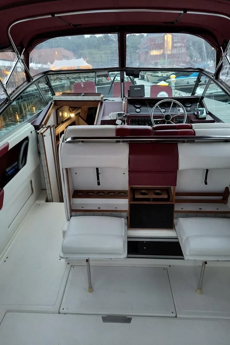 Slide: The Image of 1989 Sea Ray 268 Sun Dancer boat interior with maroon and white seating. - 22