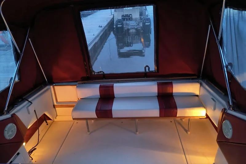 Slide: The Image of 1989 Sea Ray 268 Sun Dancer boat interior with cushioned seating and ambient lighting. - 24