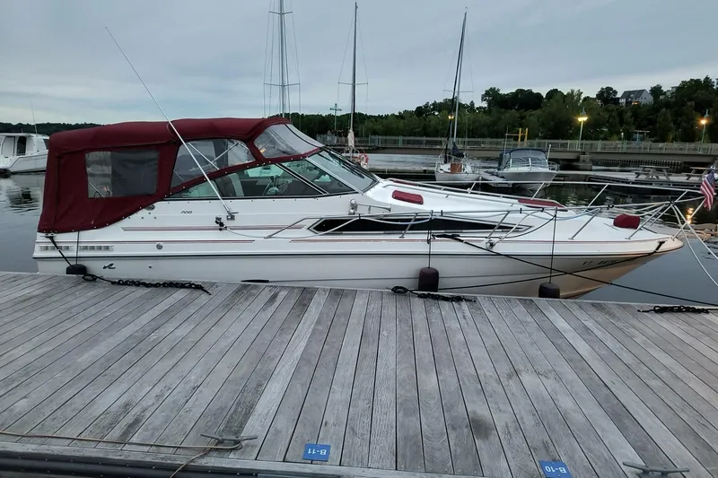 Slide: The Image of 1989 Sea Ray 268 Sun Dancer docked at a marina with red canopy. - 26