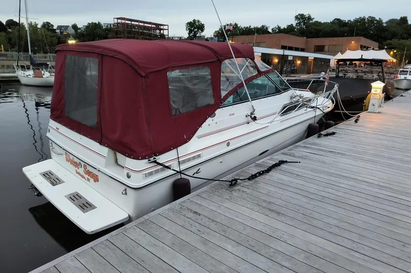 Slide: The Image of 1989 Sea Ray 268 Sun Dancer boat docked with maroon canopy in a marina. - 27