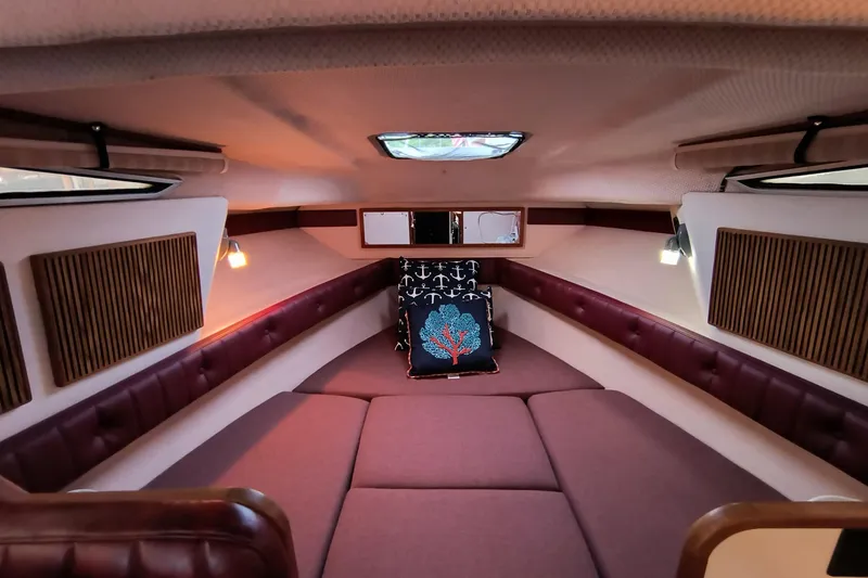 Slide: The Image of 1989 Sea Ray 268 Sun Dancer cabin interior with cozy seating and nautical decor. - 6