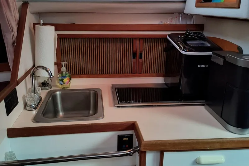 Slide: The Image of 1989 Sea Ray 268 Sun Dancer galley with sink, stove, and coffee maker. - 7