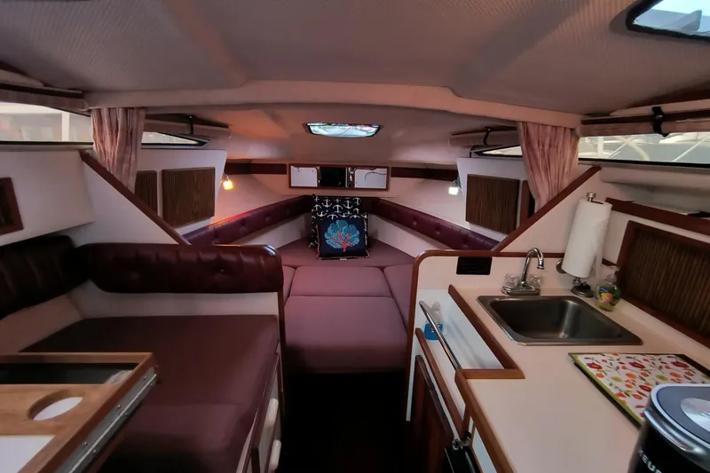 Slide: The Image of Interior of 1989 Sea Ray 268 Sun Dancer boat with cozy seating and kitchenette. - 8