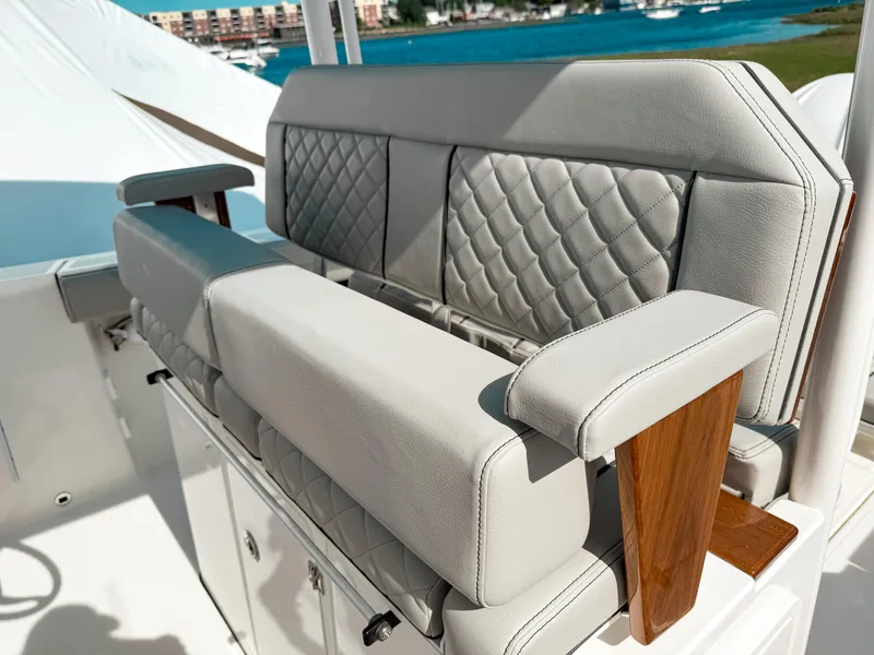 Slide: The Image of 2025 Pursuit S 288 Sport boat with luxurious quilted seating and wooden accents. - 12