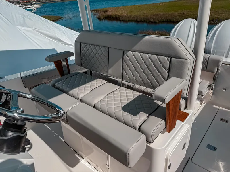 Slide: The Image of 2025 Pursuit S 288 Sport boat interior with luxurious seating and steering wheel. - 13