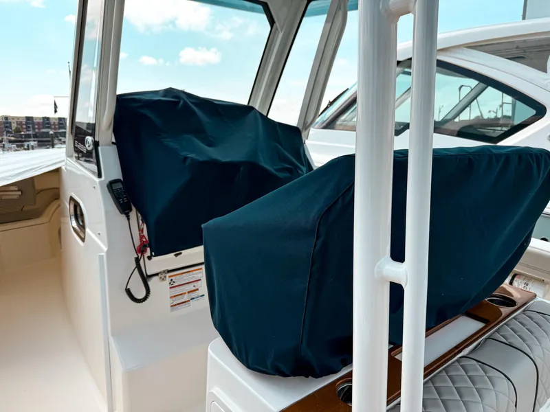 Slide: The Image of 2025 Pursuit S 288 Sport boat interior with covered seats and modern design. - 17