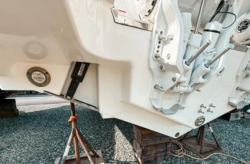 Slide: The Image of 2025 Pursuit S 288 Sport boat hull on stands, showcasing engine mount details. - 19