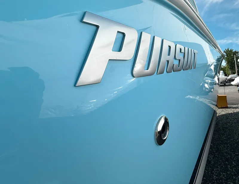 Slide: The Image of 2025 Pursuit S 288 Sport boat with sleek blue exterior and bold logo. - 2