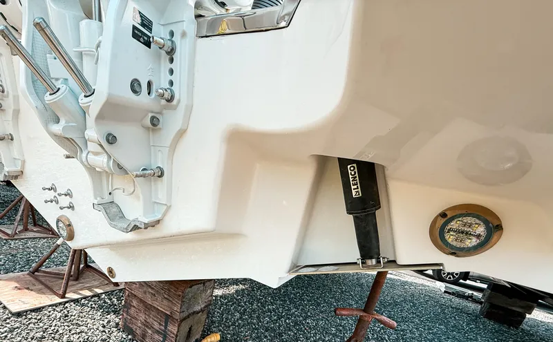 Slide: The Image of 2025 Pursuit S 288 Sport boat hull detail with trim tab and mounting hardware. - 20
